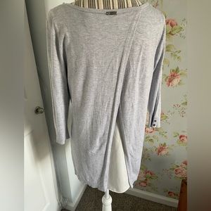 Very cute dressy tunic style sweater with stylish sheer inset in the back.